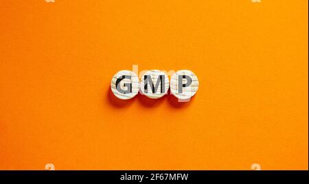 GMP, good manufacturing practice symbol. Concept words GMP, good manufacturing practice on circles on a beautiful orange background. Business and GMP, Stock Photo