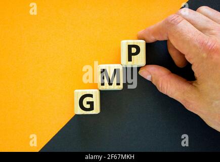 GMP, good manufacturing practice symbol. Concept words GMP, good manufacturing practice on cubes on a beautiful orange background. Business and GMP, g Stock Photo