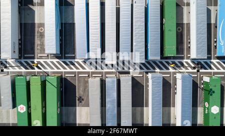 direct overhead view of truck trailers waiting to load or unload their goods Stock Photo