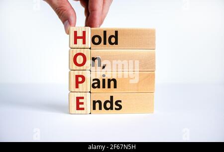 HOPE, hold on, pain ends symbol. Wooden cubes with words 'HOPE, hold on, pain ends. Beautiful white background, copy space. Business, motivational and Stock Photo