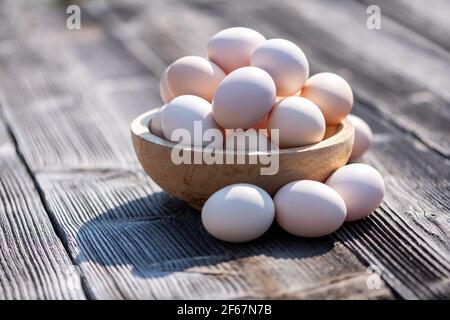 Organic chicken eggs in wooden plate Stock Photo