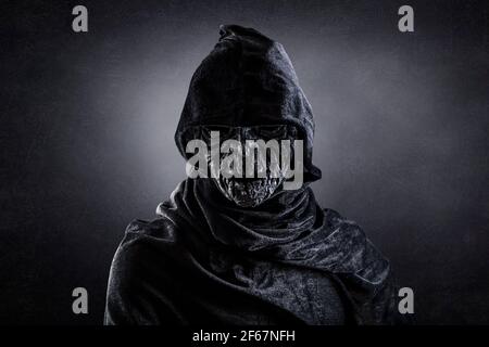 Portrait of a scary witch in hooded cloak Stock Photo - Alamy