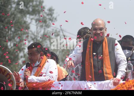 EAST MIDNAPORE, INDIA - MARCH 30: Union Home minister Amit Shah during a road show in support of Suvendu Adhikari (L), the BJP candidate for Nandigram constituency, at Nandigram on March 30, 2021 in East Midnapore, India. Nandigram has now become a prestige battle for sitting chief minister Mamata Banerjee and her former lieutenant and now BJP candidate Suvendu Adhikari. Nandigram is the birthplace of the historic land movement that propelled Mamata Banerjee to power by dethroning the Left in 2011. To win what is now being seen as the biggest battle of Bengal, Mamata Banerjee has decided to ca Stock Photo