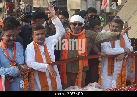EAST MIDNAPORE, INDIA - MARCH 30: Actor Mithun Chakraborty is seen during a road show for BJP candidate from Nandigram constituency Suvendu Adhikari (L), at Nandigram on March 30, 2021 in East Midnapore, India. Nandigram has now become a prestige battle for sitting chief minister Mamata Banerjee and her former lieutenant and now BJP candidate Suvendu Adhikari. Nandigram is the birthplace of the historic land movement that propelled Mamata Banerjee to power by dethroning the Left in 2011. To win what is now being seen as the biggest battle of Bengal, Mamata Banerjee has decided to camp in Nandi Stock Photo