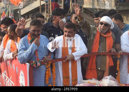 EAST MIDNAPORE, INDIA - MARCH 30: Actor Mithun Chakraborty is seen during a road show for BJP candidate from Nandigram constituency Suvendu Adhikari (L), at Nandigram on March 30, 2021 in East Midnapore, India. Nandigram has now become a prestige battle for sitting chief minister Mamata Banerjee and her former lieutenant and now BJP candidate Suvendu Adhikari. Nandigram is the birthplace of the historic land movement that propelled Mamata Banerjee to power by dethroning the Left in 2011. To win what is now being seen as the biggest battle of Bengal, Mamata Banerjee has decided to camp in Nandi Stock Photo