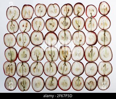 Translucent slices of ripe red grapes macro. Isolated on white. Flat lay, top view. Stock Photo