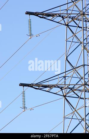 Detail of a electricity pole for transportation of electricity with a clear blue sky Stock Photo