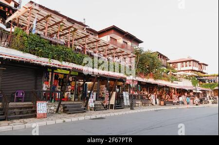 Nessebar, Bulgaria - July 20, 2014: Coastal street of Nessebur old town, small tourist shops and restaurants are on the roadside Stock Photo