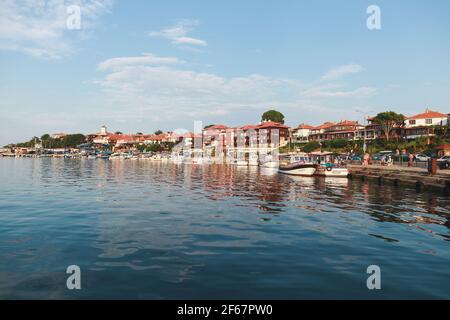 Nessebar, Bulgaria - July 20, 2014: Coastal view of Nessebar old town. Ordinary people walk the street Stock Photo