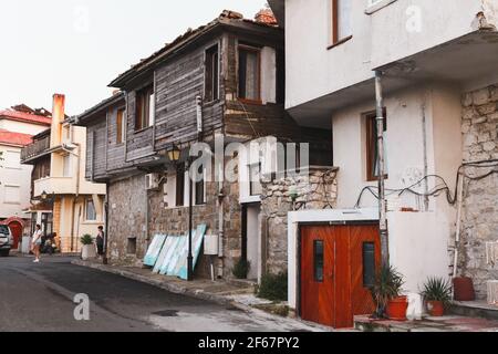 Nessebar, Bulgaria - July 20, 2014: Street view of Nesebar old town with wooden living houses standing in the row, ordinary people are on the street Stock Photo