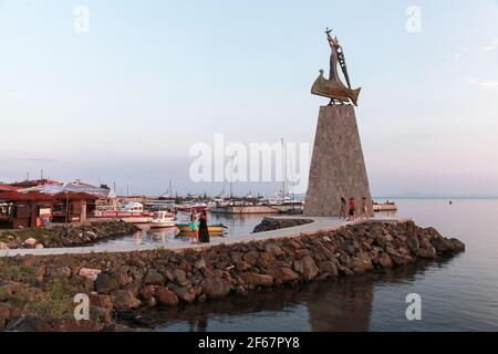 Nessebar, Bulgaria - July 20, 2014: Tourists walk near the Statue of Saint Nicholas in Nessebar old town Stock Photo