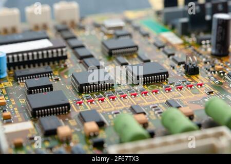 Close-up of electronic circuit board PCB with microchip, processor, integrated circuits, resistances and electronic connections. Stock Photo