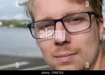 Handsome Young Man Wearing Glasses Smiling at the Camera Stock Photo