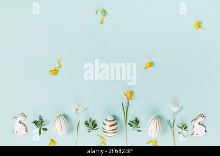 Festive Easter border, frame from easter eggs and spring flower crocus on blue background. Stylish easter flat lay blue, Stock Photo