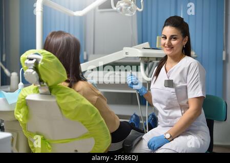 Portrait of a woman dentist while working with a patient Stock Photo
