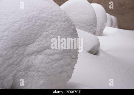 Round snowdrifts stand in a row. Geometric patern. Abstract natural background. Stock Photo