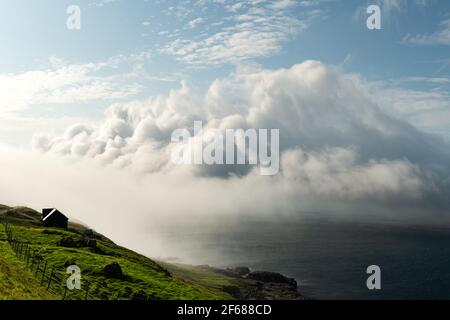 Incredible fluffy clouds over Atlantic ocean water Stock Photo
