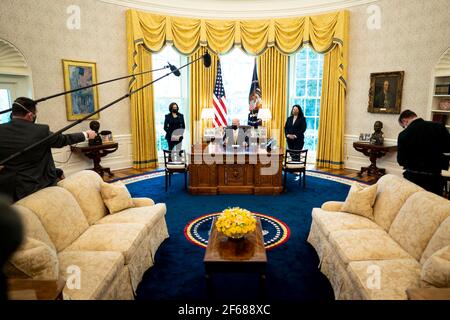 United States President Joe Biden makes remarks prior to signing the PPP Extension Act of 2021 into law in the Oval Office of the White House in Washington, DC, Tuesday, March, 30 2021. Standing at left is US Vice President Kamala Harris and at right is Isabel Guzman, Administrator, US Small Business Administration (SBA)Credit: Doug Mills/Pool via CNP | usage worldwide Stock Photo