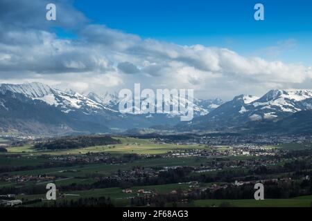Landscape view of the town of Hauteville, with the lake of Gruyere in the foreground and mountains in the background. Shot Near Fribourg, Switzerland Stock Photo