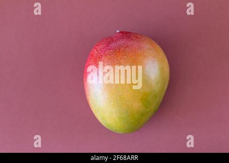 Fresh delicious mango isolated on brown background Stock Photo