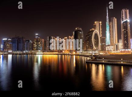 Beautiful view of the illuminated sky scrappers along with Burj khalifa captured from the Marasi drive at the Business bay district, Dubai, UAE. Stock Photo