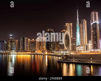 Beautiful view of the illuminated sky scrappers along with Burj khalifa captured from the Marasi drive at the Business bay district, Dubai, UAE. Stock Photo