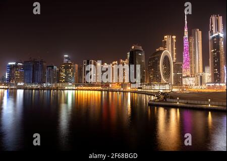 Beautiful view of the illuminated sky scrappers along with Burj khalifa captured from the Marasi drive at the Business bay district, Dubai, UAE. Stock Photo