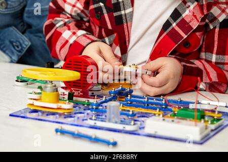 children playing with electronic constructor at studio Stock Photo