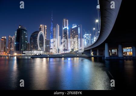 Beautiful view of the illuminated sky scrappers along with Burj khalifa captured from the Marasi drive at the Business bay district, Dubai, UAE. Stock Photo