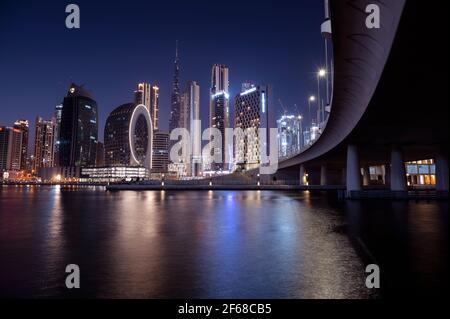 Beautiful view of the illuminated sky scrappers along with Burj khalifa captured from the Marasi drive at the Business bay district, Dubai, UAE. Stock Photo