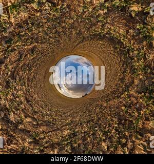 blue sky ball in middle of swirling field. Inversion of tiny planet transformation of spherical panorama 360 degrees. Curvature of space. Stock Photo