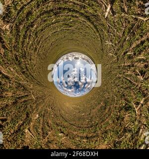 blue sky ball in middle of swirling field. Inversion of tiny planet transformation of spherical panorama 360 degrees. Curvature of space. Stock Photo
