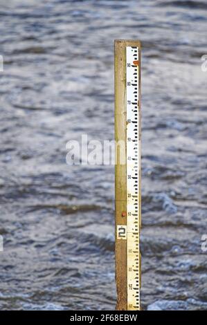 High water measuring guide to gauge the level of water in the Alouette River, Pitt Meadows, B. C., Canada.  Stock photo. Stock Photo
