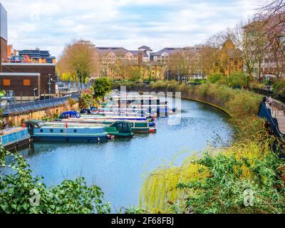 Grand Union Canal and motorboats docked near Maida Avenue and Little Venice in London, in the spring season - UK Stock Photo