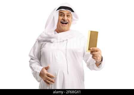 Mature arab man holding a gold bar and smiling isolated on white background Stock Photo