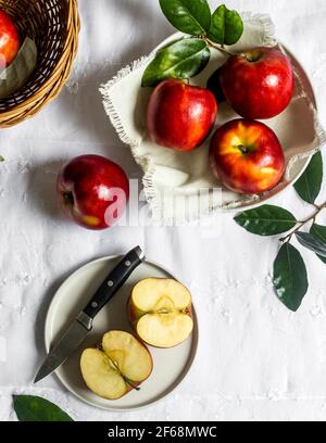 Kitchen scene of freshly picked, ripe, delicious, sweet and juicy red apples being washed and cut to be eaten and enjoyed as a healthy snack. Stock Photo