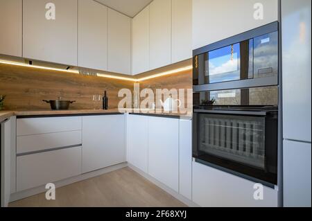 Modern white and beige wooden kitchen interior Stock Photo