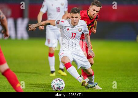 LEUVEN, BELGIUM - MARCH 30: Vitali Lisakovich of Belarus and Leandro Trossard of Belgium during the FIFA World Cup 2022 Qatar Qualifier match between Stock Photo