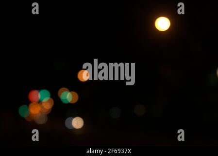 Abstract city night lights circular blurry background. Beautiful yellow, green colors bokeh. Horizontal image style. Stock Photo