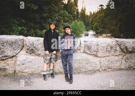 Two Buddies Pose for Photo on Stone Bridge over Merced River