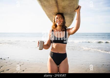Woman Enjoying Morning Coffee before Surf Stock Photo