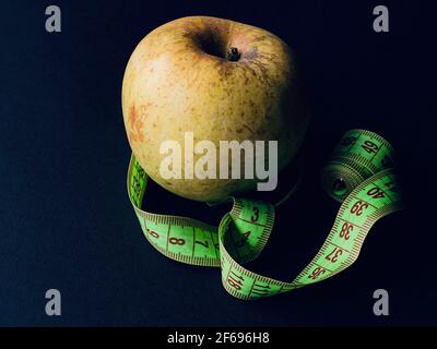 green apple with meter on black background Stock Photo