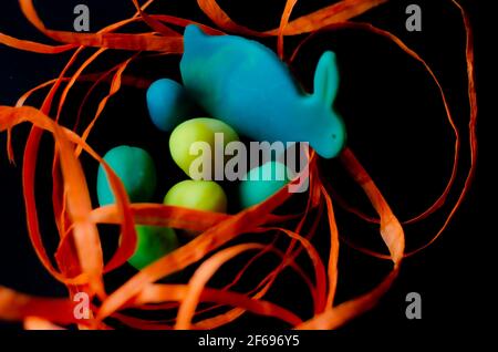Easter decor with orange ribbon on black background Stock Photo