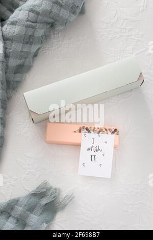 Two colorful presents on a white quilt with a positive message pasted on it. "I worth it" Stock Photo