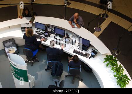 2019-11-04 - Rome, Italy - Three customer service agents working at a help desk in Fiumicino Airport. Stock Photo