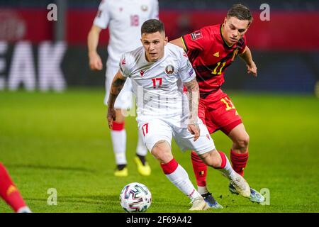 LEUVEN, BELGIUM - MARCH 30: Vitali Lisakovich of Belarus and Leandro Trossard of Belgium during the FIFA World Cup 2022 Qatar Qualifier match between Stock Photo