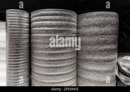 Silver rolls of insulation material, building materials in a hardware store. Stock Photo