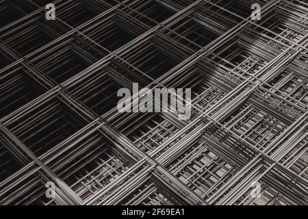 Metal bars in diagonal lines close-up, mesh of steel wire, texture of building material. Stock Photo