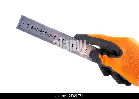 Hand-held metal ruler for mechanical measurements. Accessories for precision measuring in a gloved hand. Light background. Stock Photo