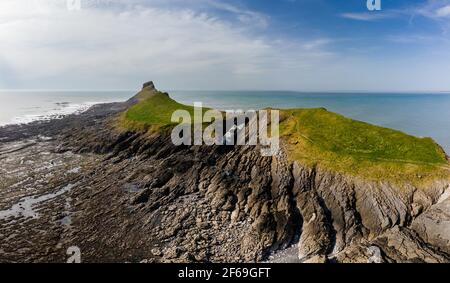 Panoramic aerial view of a spectacular rocky coastline at low tide (Worm's Head, Wales, UK) Stock Photo